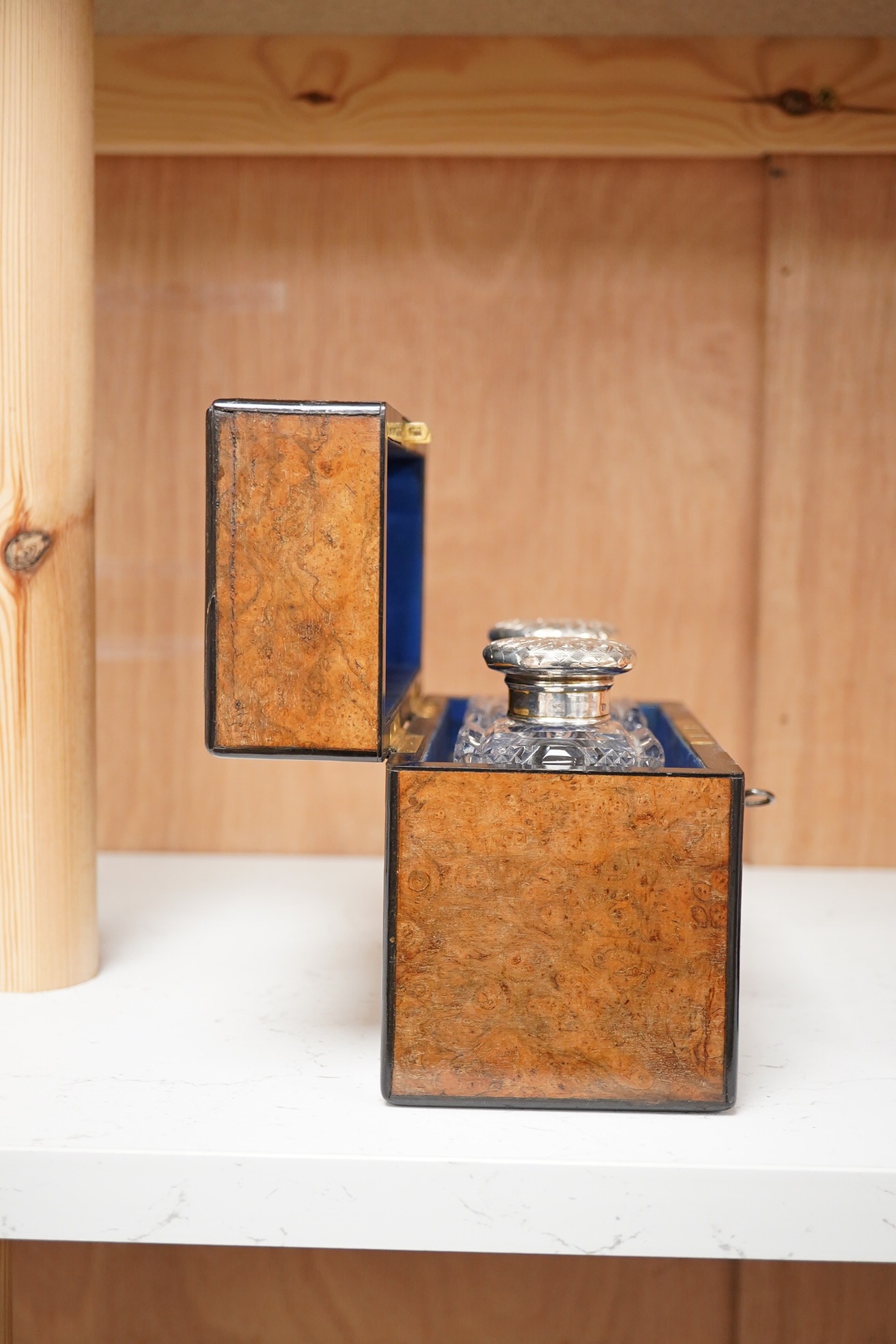 A Victorian burr walnut cased pair of silver topped perfume bottles, retailed by Piesse and Lubin, 11cm high. Condition - box cracked at the top/side, bottles good